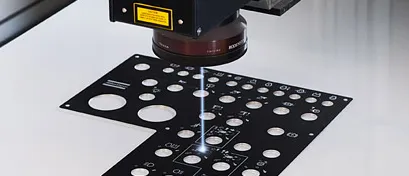 Lasermärkning av metalldetalj med gnistor i Aluscreens verkstad